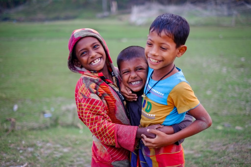 South asian rural kids passing happy time together in a riverside area